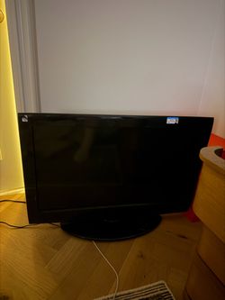 Black Flat Screen TV with Stand
