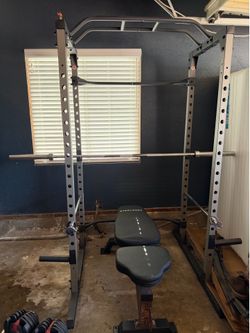 Squat rack with Olympic weight set, barbell and hex bar