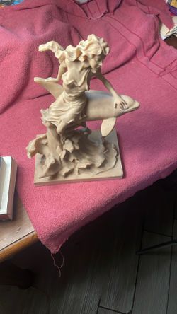 Lady Seating On A Dolphin Statue