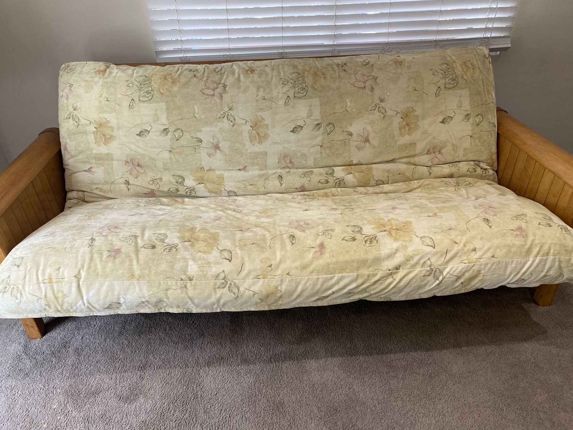 Wood frame queen size futon with mattress cover.