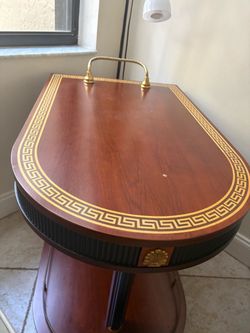 A brown cart with a Versace design drawn by hand.