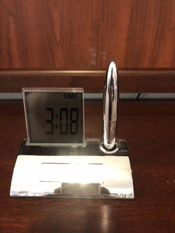Decorative digital clock and pen. Clock lights up