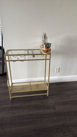 Gold bar cart with bar essentials