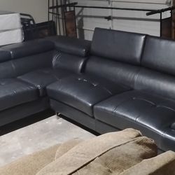 Like new leather couch with fold up back rests and storage compartment s