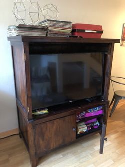 Sturdy armoire/entertainment unit.. has doors to cover TV (not shown)