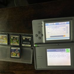 silver Nintendo Ds with 5 games a game case
