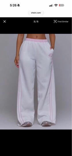 Musera white sweatpants with pink stripes along the sides