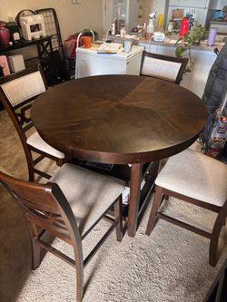 Round dining room table with four chairs