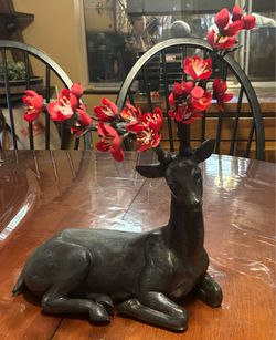 Lying deer with flower antlers