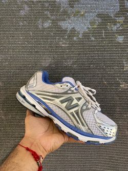 New Balance 1224 running shoe in white, silver, and blue.