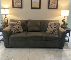 Dark grey sofa and loveseat and cushions