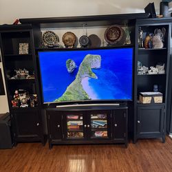 Entertainment center (4-piece set), Ashley Furniture brand. Includes a 65-inch curved Samsung TV. Price: $600 or best offer.