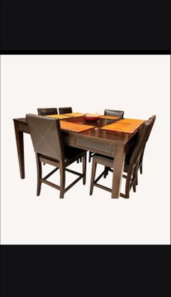 cherry wood bar height dining room table extendable  with leather trim and 6 chairs.
