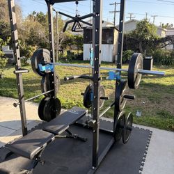 Complete gym set up. In like new condition first day outside  comes with bar Olympic weights set adjustable bench  and lat pull dawn attachment and so