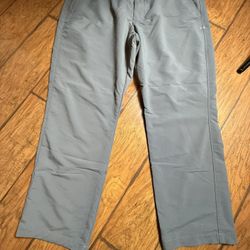 A pair of gray Under Armour Match Play Golf Pants Size 40/30  40 inches waist and a 30 inch inseam  Very good condition  Smoke free home