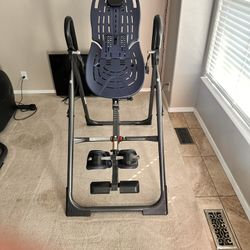 Teeter Inversion Table, specifically a model from their FitSpine or EP-series, designed to provide natural back pain relief and improve spinal health 