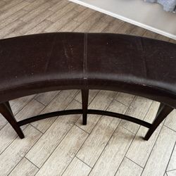 Curved cushioned bench for counter height table