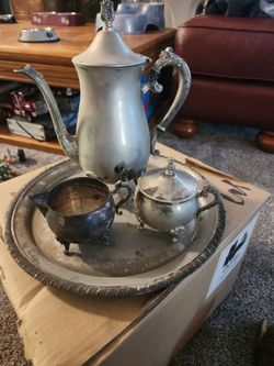 vintage silver plated footed tea pot with sugar bowl and creamer and platter is a charming.