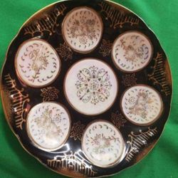 Vintage Lefton Saucer with opalescent finish decorated with black and gold details. A37M974