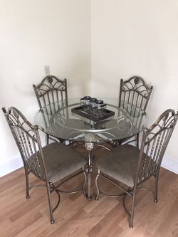 Round glass dining table and four chairs