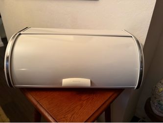 White Brabantia roll top bread bin with metal body and chrome trim