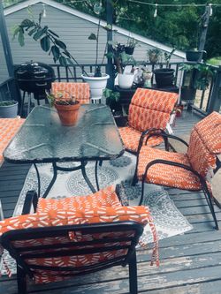Large patio table with 4 chairs and cushions