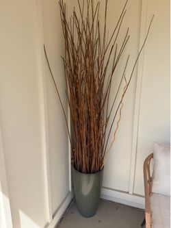 Outside decor pot with decorative sticks / reeds.