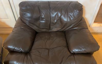 Brown leather couch and loveseat