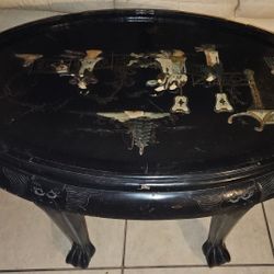 Oval coffee table with intricate Asian-themed design. 43” length, 30” wide.   6 stools that fit under table Cabinet32wide29”high13”depth.Chinese Table