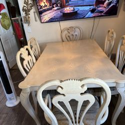 Dining room table 6 chairs, two with arms on them