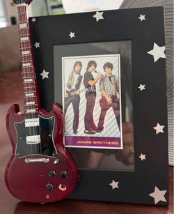 Jonas Brothers picture framed with stars.