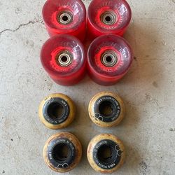 2 sets of skateboard wheels, light-up cruiser wheels, skate wheels.