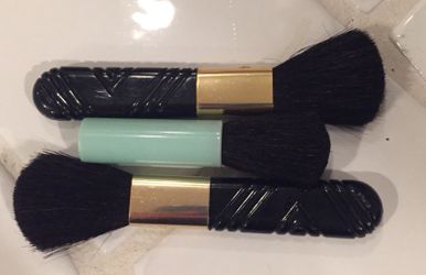Three small makeup brushes
