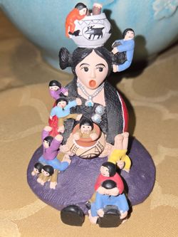 Pueblo-style Storyteller Figurine Central female figure surrounded by children.