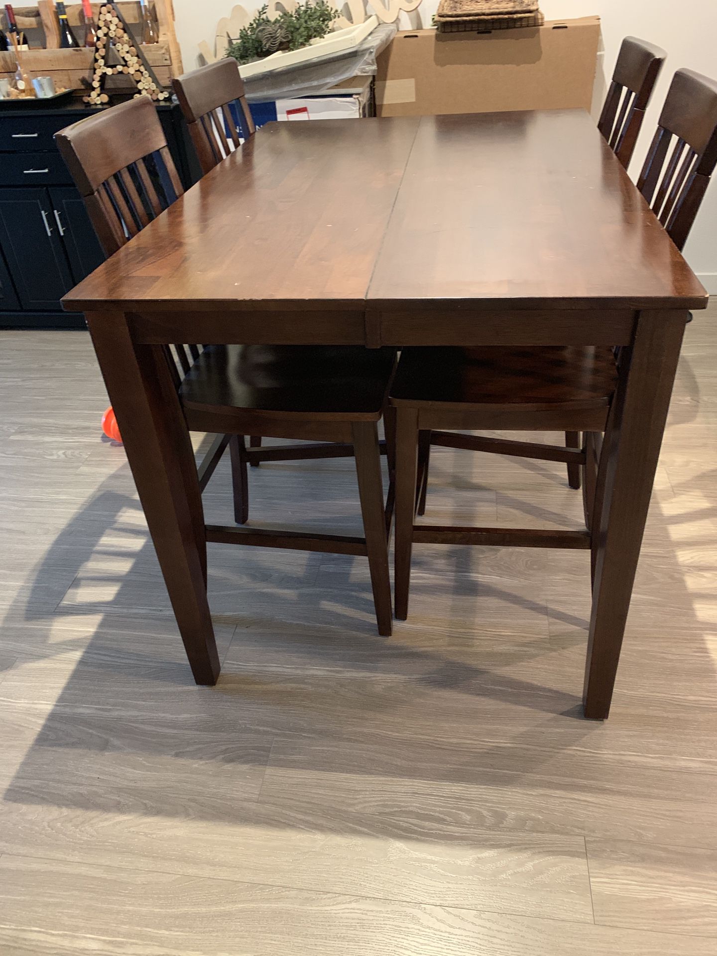 Solid wood, tall Kitchen Table with detachable leaf insert and 4 chairs.