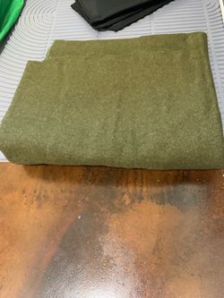 olive green military-style wool blanket folded