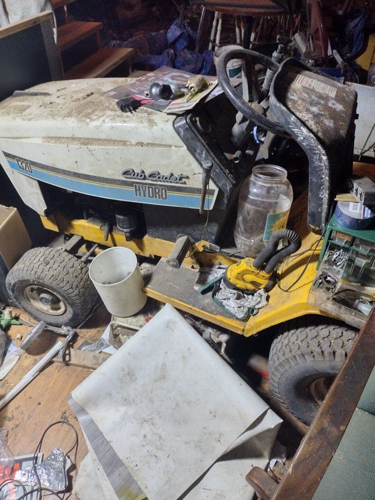 2 cub cadet riding mower and 1 craftsman lawn mower and a quad