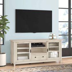 Tv Stand New in Packaging With Adjustable Shelves and Tempered Glass Doors Retailed For $419.12.