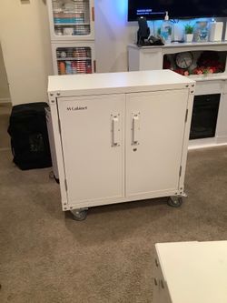 White metal cabinet on wheels dimensions height 34 inches width 32 and a half