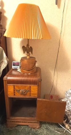 antique waterfall nightstand with antique eagle lamp both items included in price