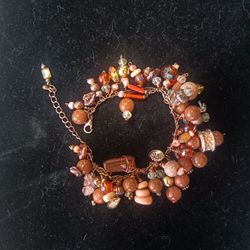Statement bracelet hand made with copper, coral,pearls,gold play,quartz , sandstone, Amber, crystal.