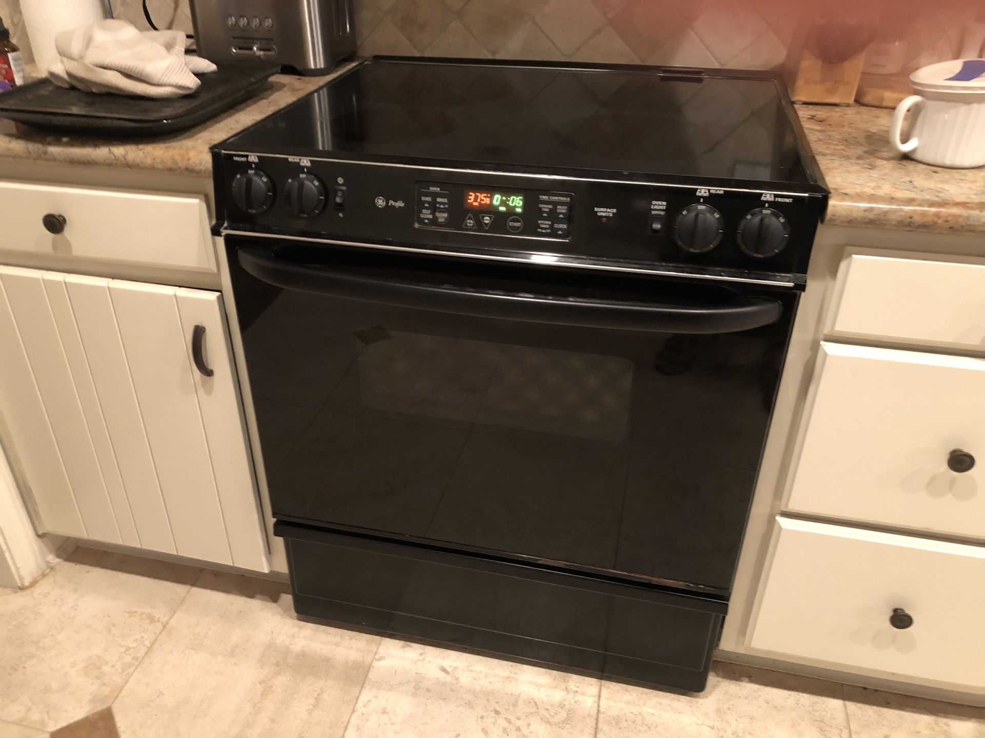 GE profile black electric smooth top range. Great condition, clean inside and out.