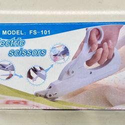 Electric scissors with a white handle 