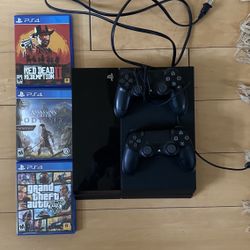 PlayStation 4 with controllers and games