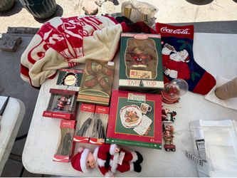 vintage Coca-Cola holiday memorabilia, including ornaments, a plush doll, and decorative items.Ornaments:
