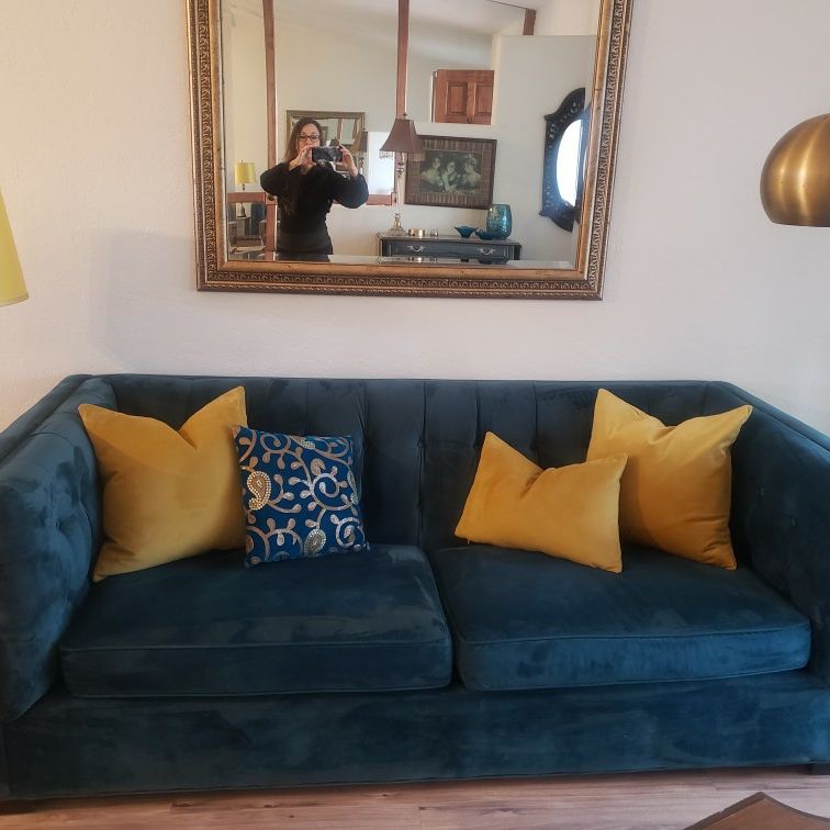 Blue Velvet Sofa With Yellow Pillows