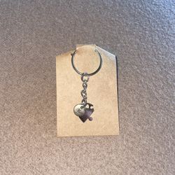 Puzzle Piece “K” keychain with a heart cutout