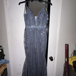 Silver-blue sparkly gown with V‑neck & thin straps.