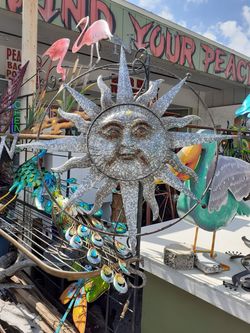 Cool large metal sunface wall art with compass surrounding it