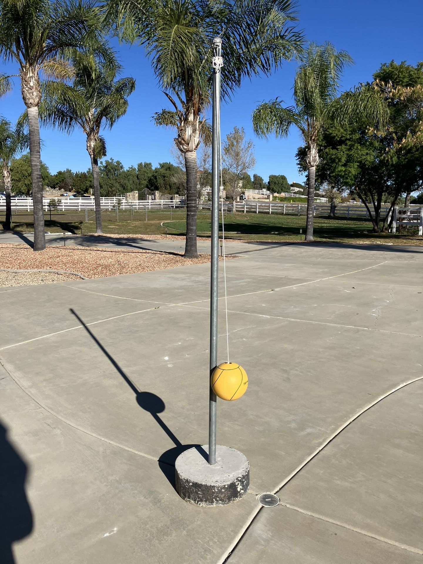 Tetherball pole with concrete base and ball